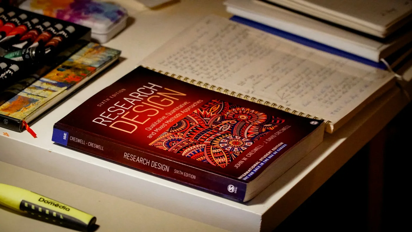 Research design book and notes representing source verification